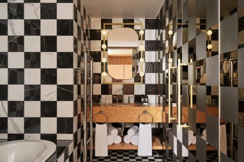 a bathroom with a black and white checkered wall at W Budapest in Budapest