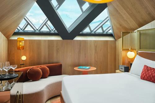 a bedroom with a large white bed and a window at W Budapest in Budapest
