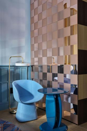 a room with a blue chair and a table at W Budapest in Budapest