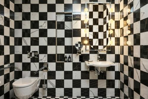 a bathroom with a black and white checkered wall at W Budapest in Budapest