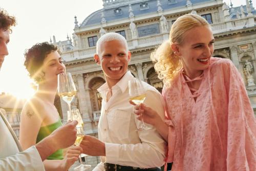 a group of people drinking wine in front of a building at W Budapest in Budapest