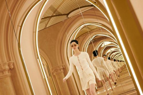 a model walks down a hallway in a dressing room at W Budapest in Budapest