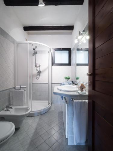 a bathroom with a shower and a sink and a toilet at Caletta Nest 93 in Porto Rotondo