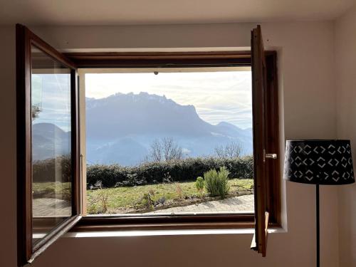 a window with a view of a mountain view at Cocon des Alpes in Vinzier