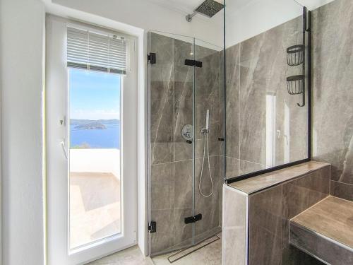 a bathroom with a shower with a glass door at Mediterranean Beauty in Skiathos
