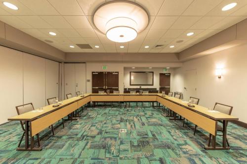 a large room with tables and chairs and a screen at Courtyard by Marriott Greenville Downtown in Greenville
