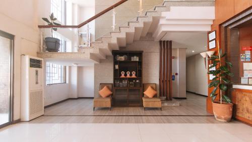 a hallway with a staircase in a building at Bliss Hotel San Fernando Pampanga City in San Fernando