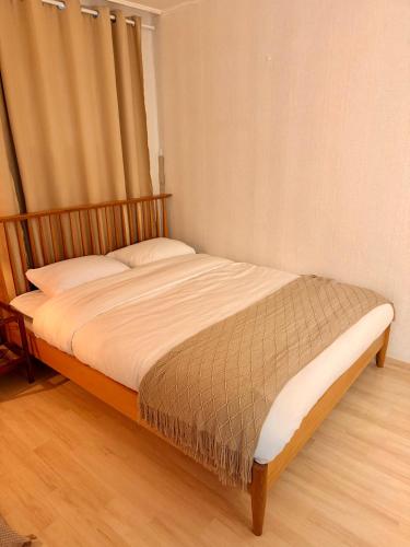 a bed sitting in a bedroom with a window at KSPO,JYP,LotteTower, Sodamjae Stay in Seoul