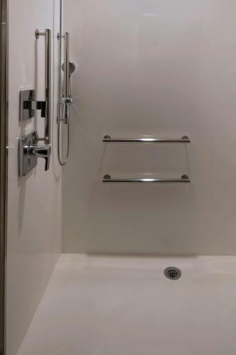 a shower in a bathroom with a silver showeriterator at Courtyard by Marriott Guatemala City in Guatemala