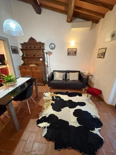 a living room with a cow rug on the floor at Apartment Marilù in Greve in Chianti