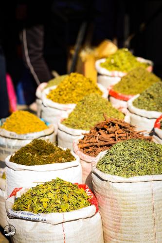 a row of baskets filled with different spices and herbs at Superides Camp in Ourika