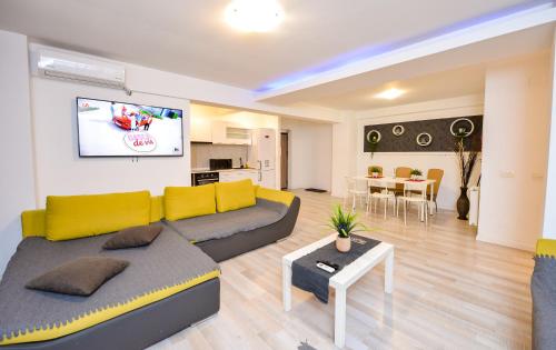 a living room with a couch and a table at Downtown Accommodation in Bucharest