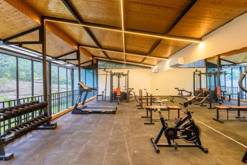 a gym with treadmills and exercise equipment in a building at DLS Divine River Resort and Spa, Rishikesh in Rishīkesh