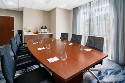 a conference room with a wooden table and chairs at Fairfield by Marriott Inn & Suites Las Vegas Stadium Area in Las Vegas