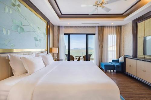 a bedroom with a large bed and a television at Renaissance Danang Hoi An Resort & Spa in Hoi An