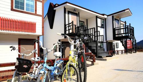 two bikes parked in front of a house at Bluesean Pension in Namhae