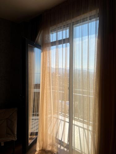 a window with a view of a city at Mandarini in Chakvi
