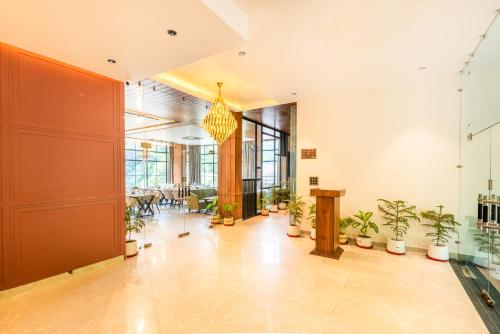 a lobby with potted plants in a building at DLS Divine River Resort and Spa, Rishikesh in Rishīkesh