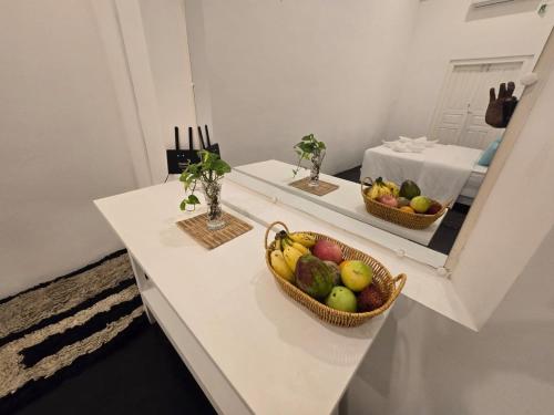 a counter with two baskets of fruit in a mirror at Sudu Colonial House 1929 in Ambalangoda