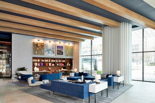 a rendering of a lobby with blue furniture at AC Hotel by Marriott Greenville in Greenville