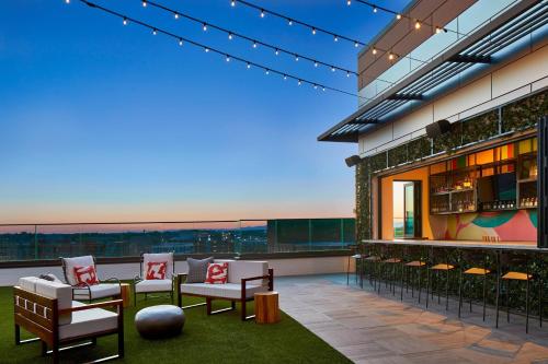 a patio with chairs and a bar on a building at AC Hotel by Marriott Greenville in Greenville