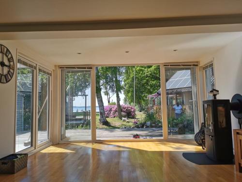 an open living room with sliding glass doors at Villa Lakeside in Osbyholm
