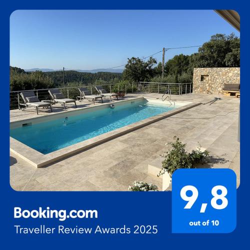 a large swimming pool with lounge chairs at LIS ESTELLO - Gîte à FLAYOSC VAR in Flayosc