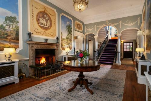 a living room with a fireplace and a table at Mount Juliet Estate, Autograph Collection in Thomastown