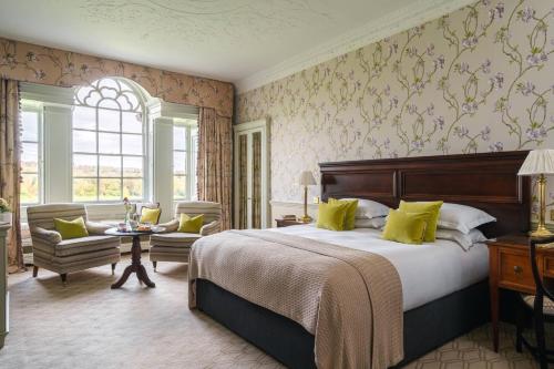 a bedroom with a bed and a chair and a table at Mount Juliet Estate, Autograph Collection in Thomastown