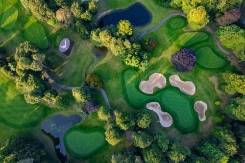 an overhead view of a golf course with trees and water at Mount Juliet Estate, Autograph Collection in Thomastown