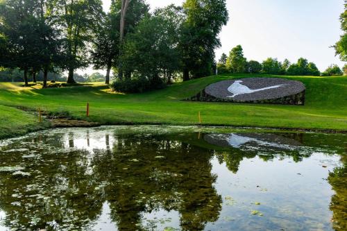 a pond with a statue of a goose on a golf course at Mount Juliet Estate, Autograph Collection in Thomastown