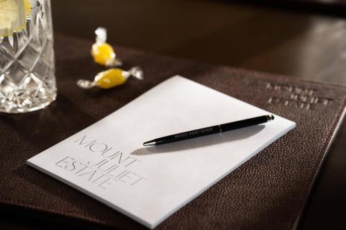 a pen sitting on top of a paper on a table at Mount Juliet Estate, Autograph Collection in Thomastown