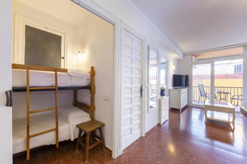 a bedroom with two bunk beds and a living room at AlmeriaSuite Impressive Beach Views in Almería