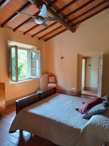 a bedroom with a large bed with a ceiling at Podere Torre Relax in Mugello in Campestri