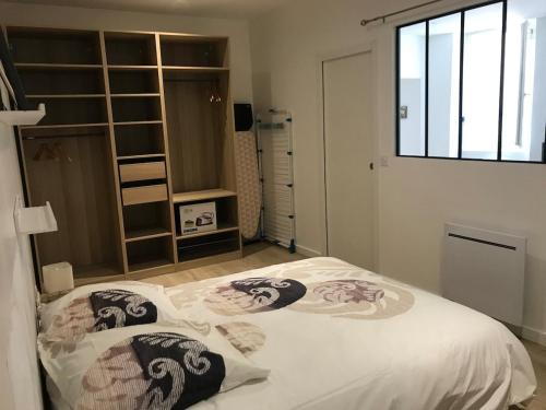 a bedroom with a bed and a window at Coeur de Saint Marcellin in Saint-Marcellin