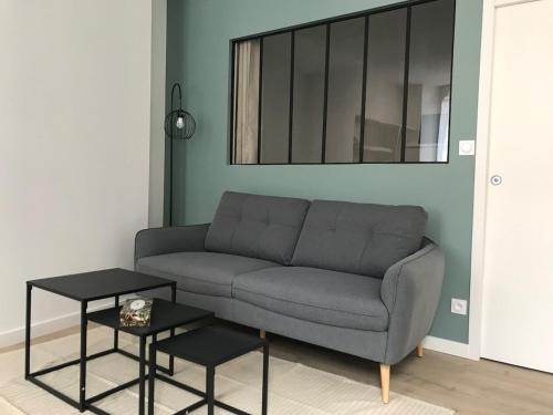 a living room with a couch and a table at Coeur de Saint Marcellin in Saint-Marcellin