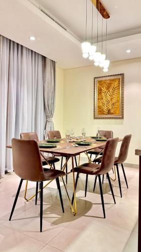 a dining room with a table and chairs at 3BR Ensuite Villa in Motor City - ShamsGetaways in Dubai