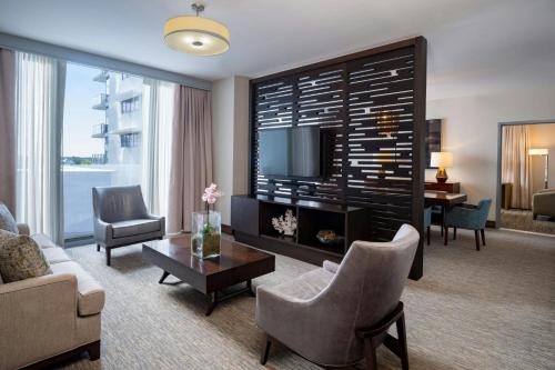 a living room with a couch and a tv at The Westin Sarasota in Sarasota