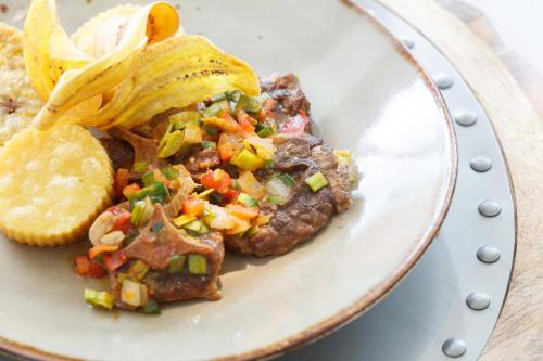 a plate of food with food and chips on it at Renaissance Wind Creek Curacao Resort in Willemstad