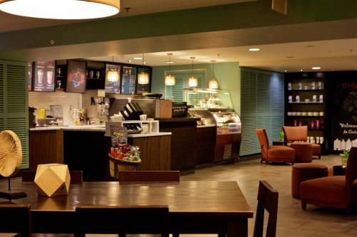 a restaurant with a table and chairs and a counter at Renaissance Wind Creek Curacao Resort in Willemstad