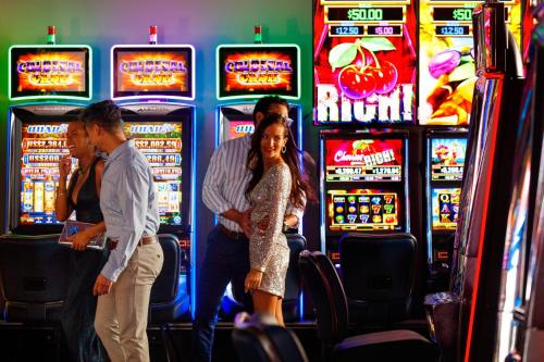 a group of people standing in front of slot machines at Renaissance Wind Creek Curacao Resort in Willemstad