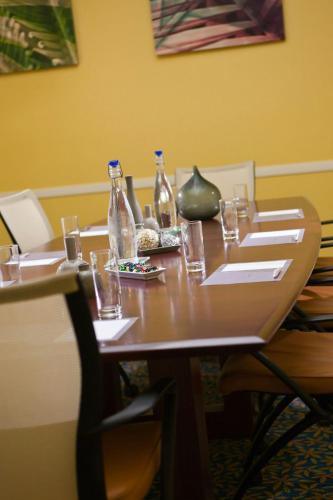 a wooden table with glasses and bottles on it at Renaissance Wind Creek Curacao Resort in Willemstad