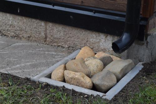 a pile of rocks sitting in a cement ledge at Penzion Slunečno in Dobšín
