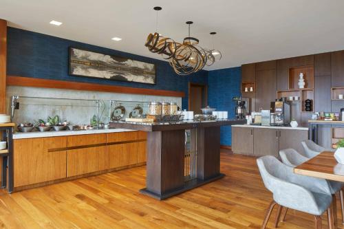 a kitchen with a large island in the middle at Renaissance Dallas at Plano Legacy West Hotel in Plano