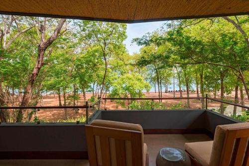 a balcony with a view of the trees at El Mangroove Papagayo, Autograph Collection in Papagayo, Guanacaste
