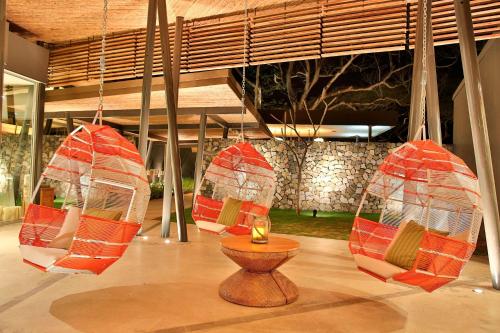 a room with four chairs hanging from a ceiling at El Mangroove Papagayo, Autograph Collection in Papagayo, Guanacaste