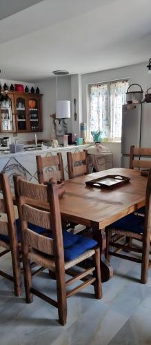 a wooden table and chairs in a kitchen at K-Rooms in Veli Iž