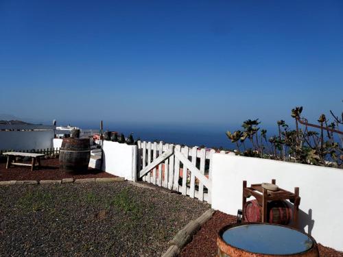 a white fence with a view of the ocean at La cuadra de Juan in Icod de los Vinos