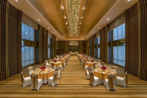 a row of tables in a large room with windows at Aloft Kathmandu Thamel in Kathmandu