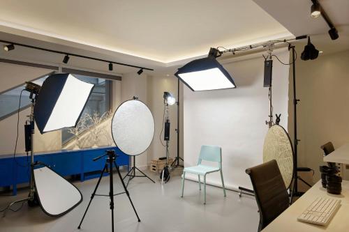 a recording studio with two mirrors and a chair at Montcalm East, Autograph Collection in London